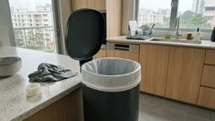 Trash bag slipping into the bin? This peelable gel tape setup keeps it in place (and makes swaps easier)